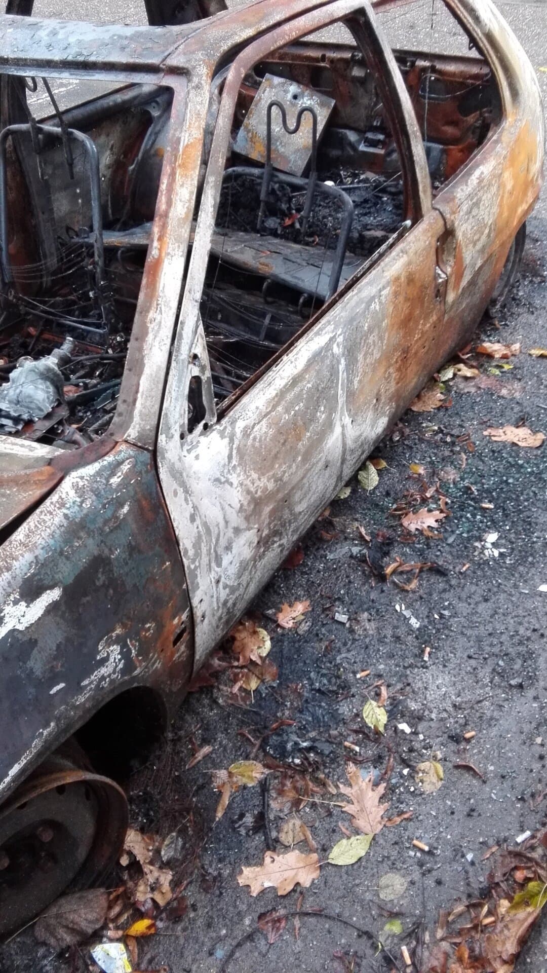 Burned passenger vehicle at a fire scene