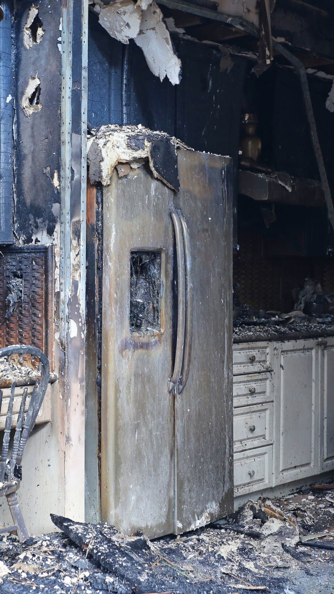 Fire-damaged residential kitchen interior